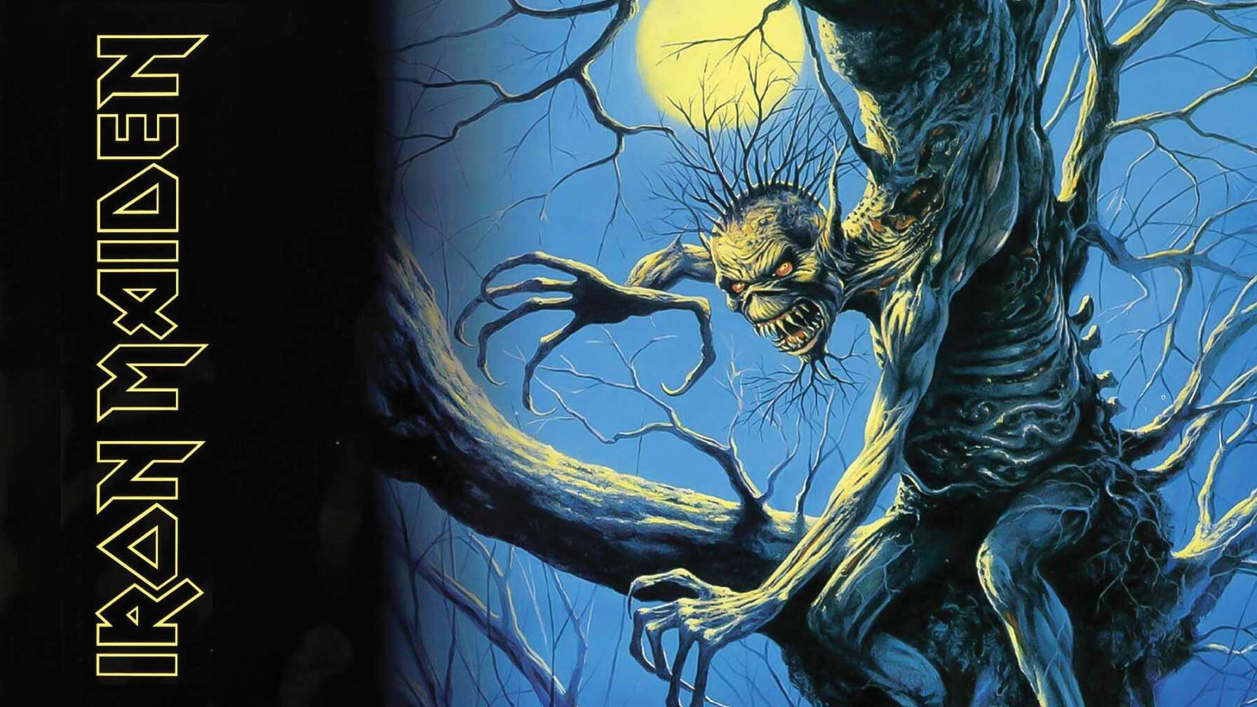 Das Cover von Iron Maidens Album "Fear of the Dark". Ein Monster in Gestalt des Band-Maskottchens Eddie schält sich aus einem Baum. Im Hintergrund leuchtet der Vollmond.